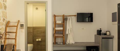 A modern bathroom with a shower, toilet, and a vanity area.