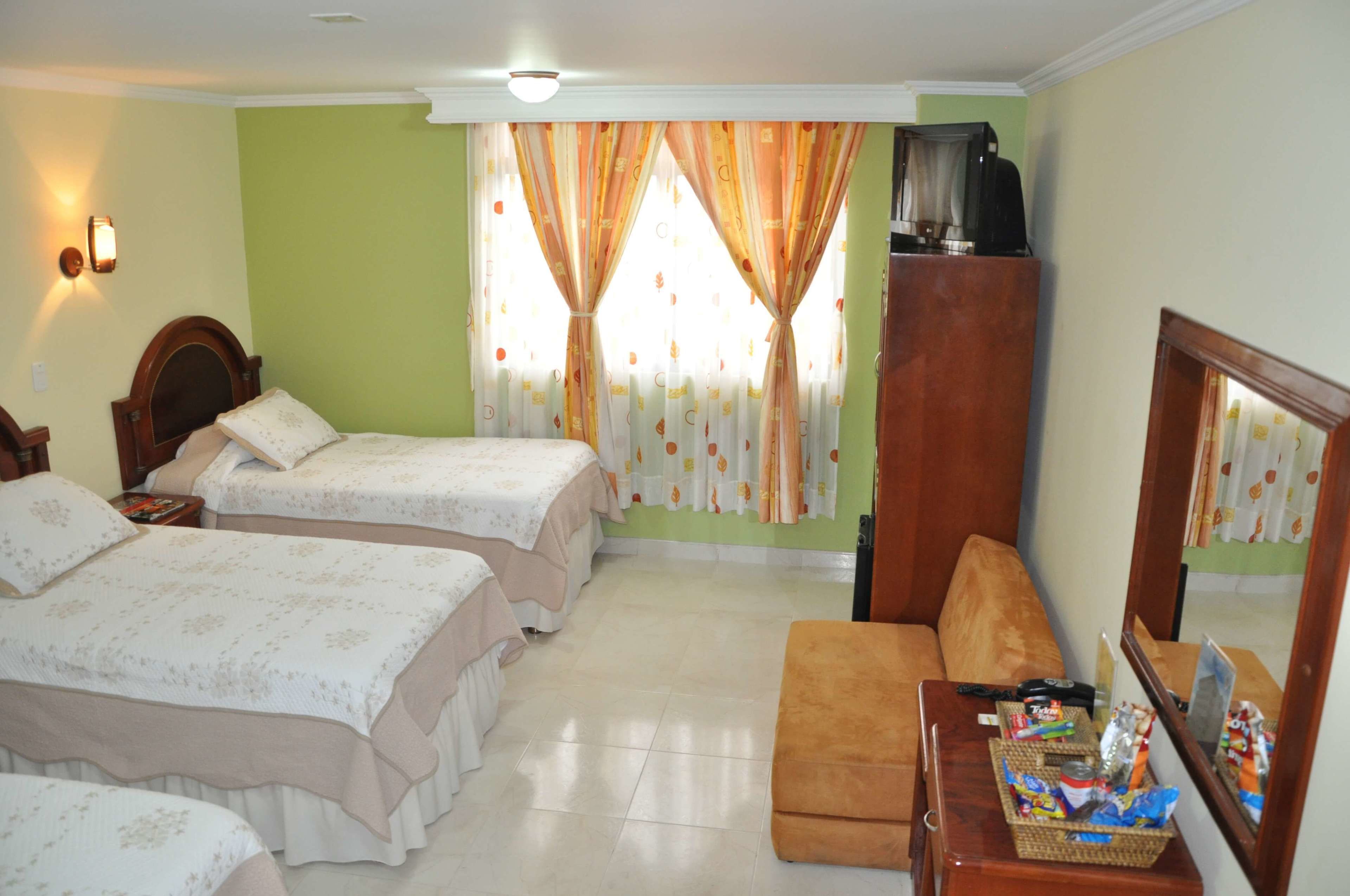 triple room, multiple beds | minibar, in-room safe, desk, iron/ironing board