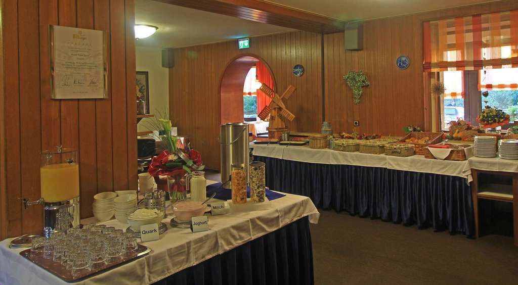 A buffet setup with various food items and drink stations, including a milk station and a juice station.