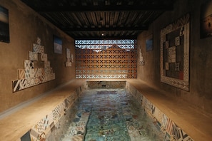 A room with a tiled floor, a wooden ceiling, and patterned walls. - Hotel los Amantes Valle de Guadalupe (Valle de Guadalupe)