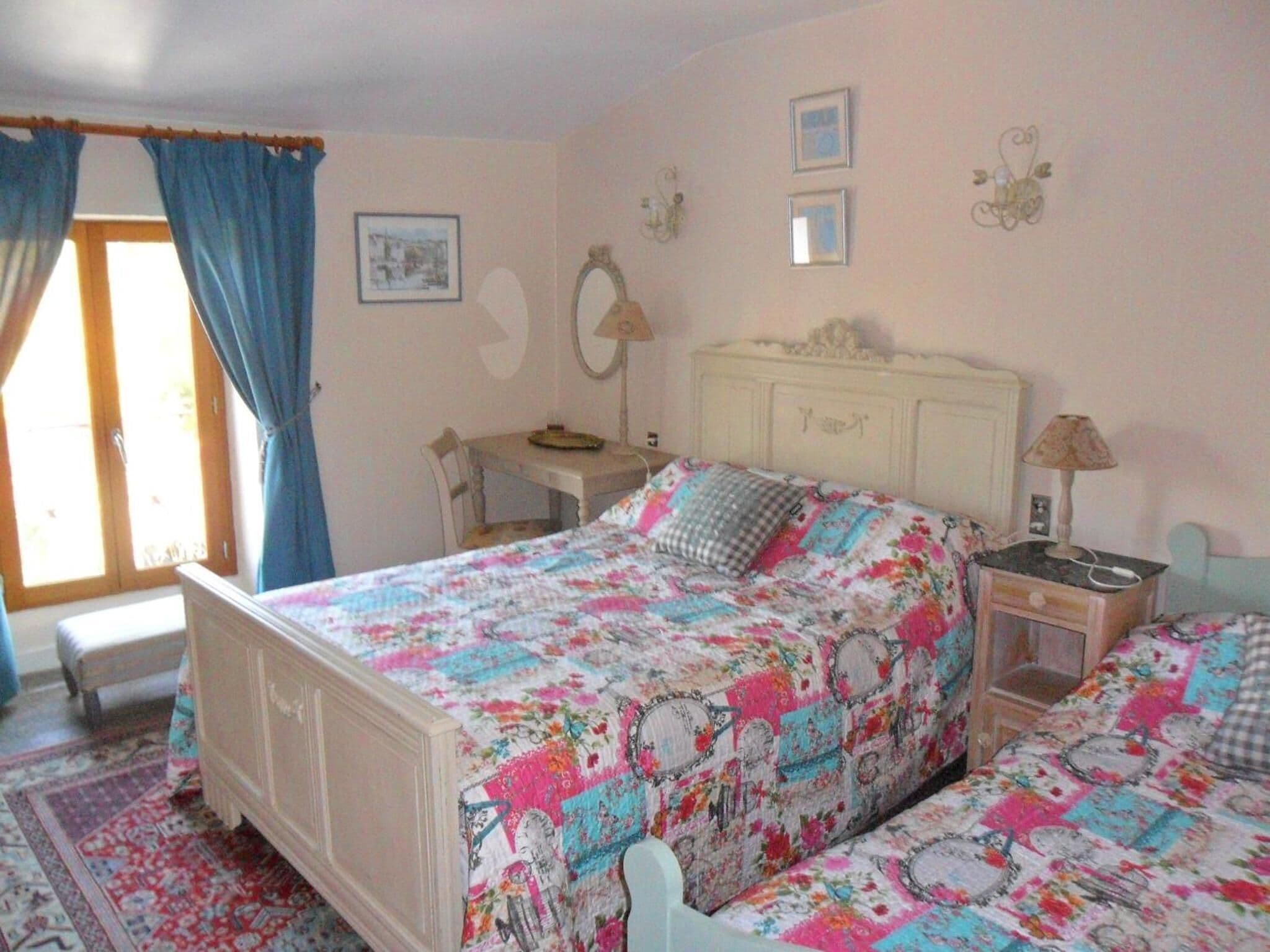 Un dormitorio con una cama, un escritorio y una silla.