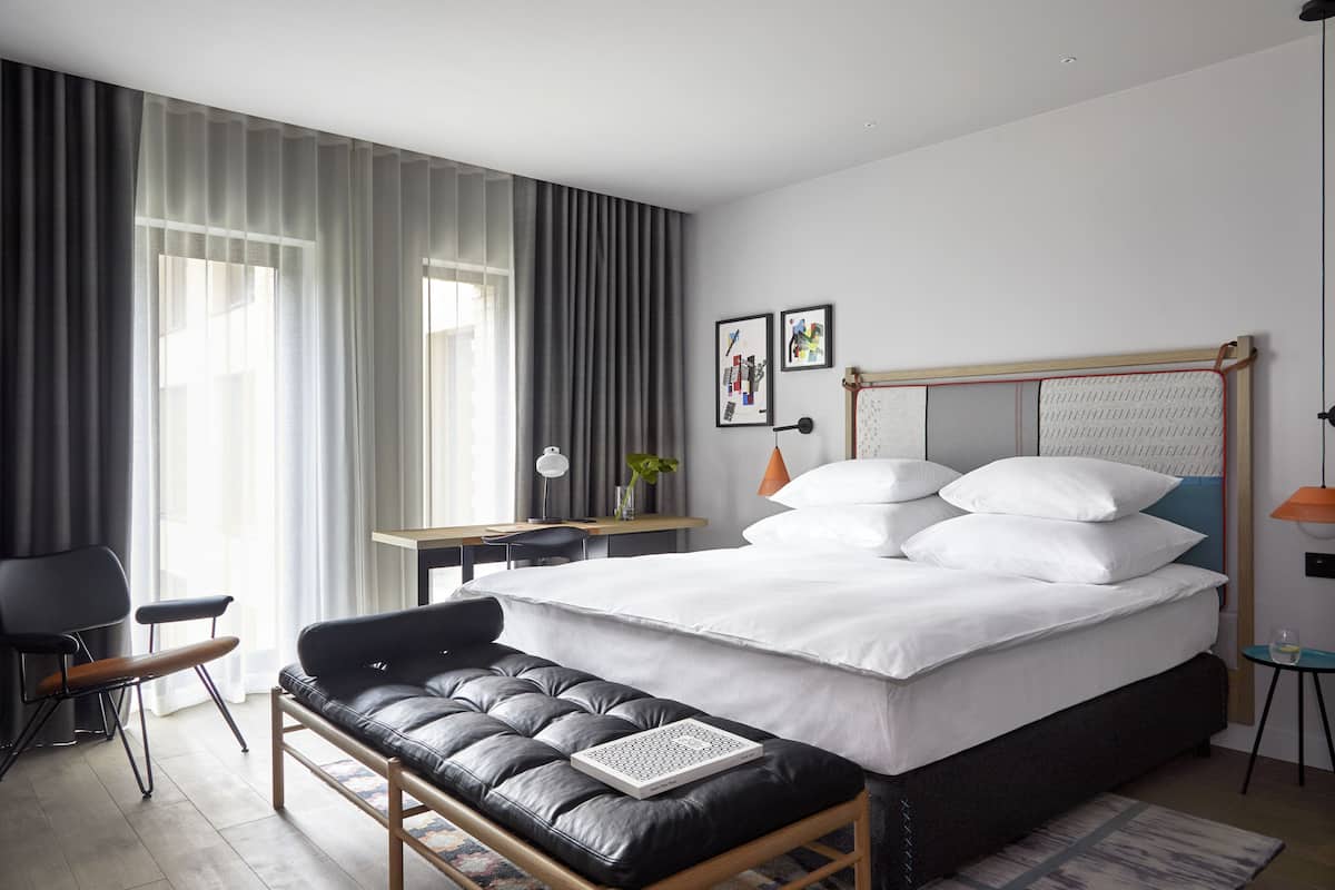 Deluxe King | Hypo-allergenic bedding, down duvets, in-room safe, desk