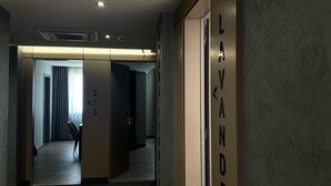 A hallway with a door labeled "LAVANDERI" and a number "210" above it. - Hotel Liss (Lezhe)