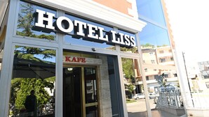 A hotel with a prominent 'HOTEL LISS' sign above the entrance. - Hotel Liss (Lezhe)