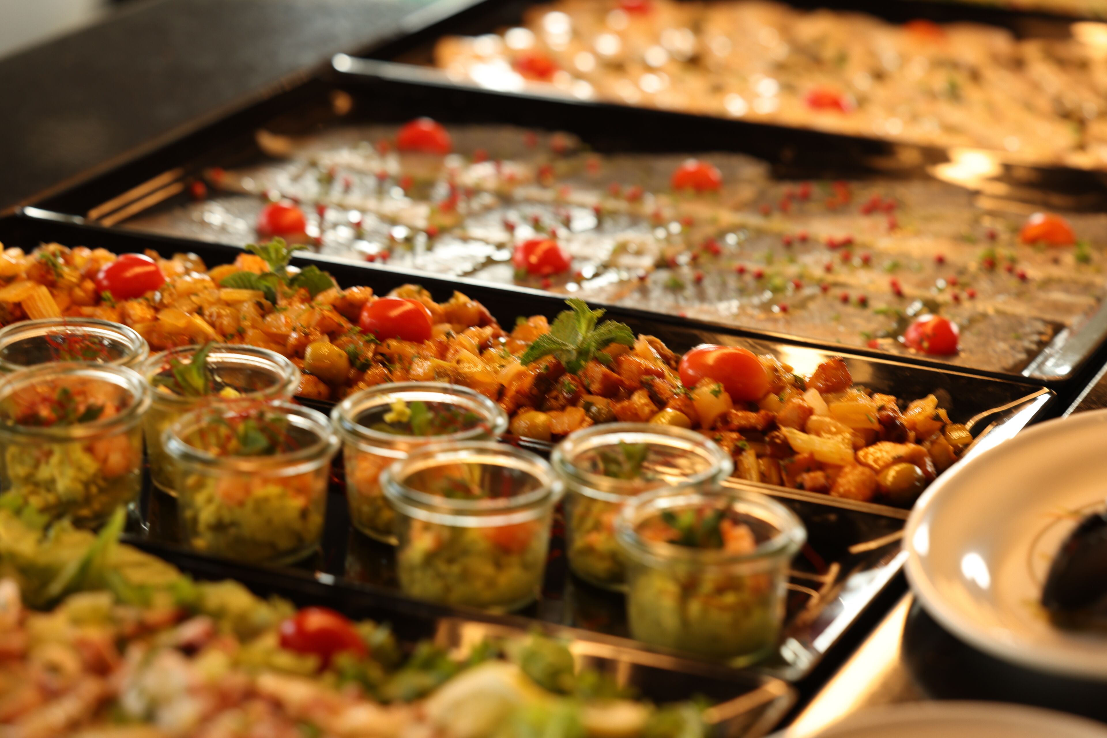 A buffet with various dishes and garnishes.