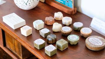 A wooden table displaying various cheese wheels with labels.