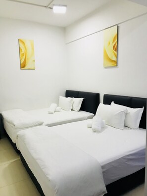 A hotel room with three single beds, white bedding, and two yellow floral wall art pieces. - H-Hotel (Johor Bahru)