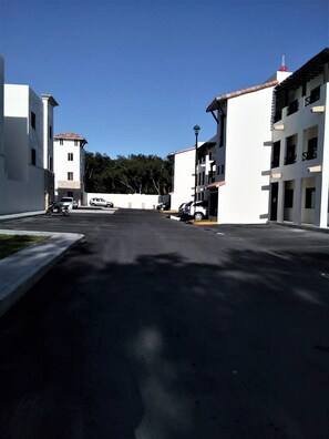 Stroll down this quiet residential street lined with modern two-story buildings.