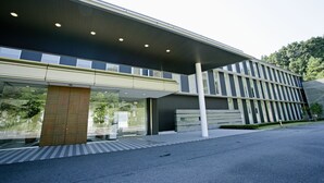 A modern building with a covered walkway, large windows, and a flat roof. - Menard Aoyama Resort Hotel Schönvert (Iga)