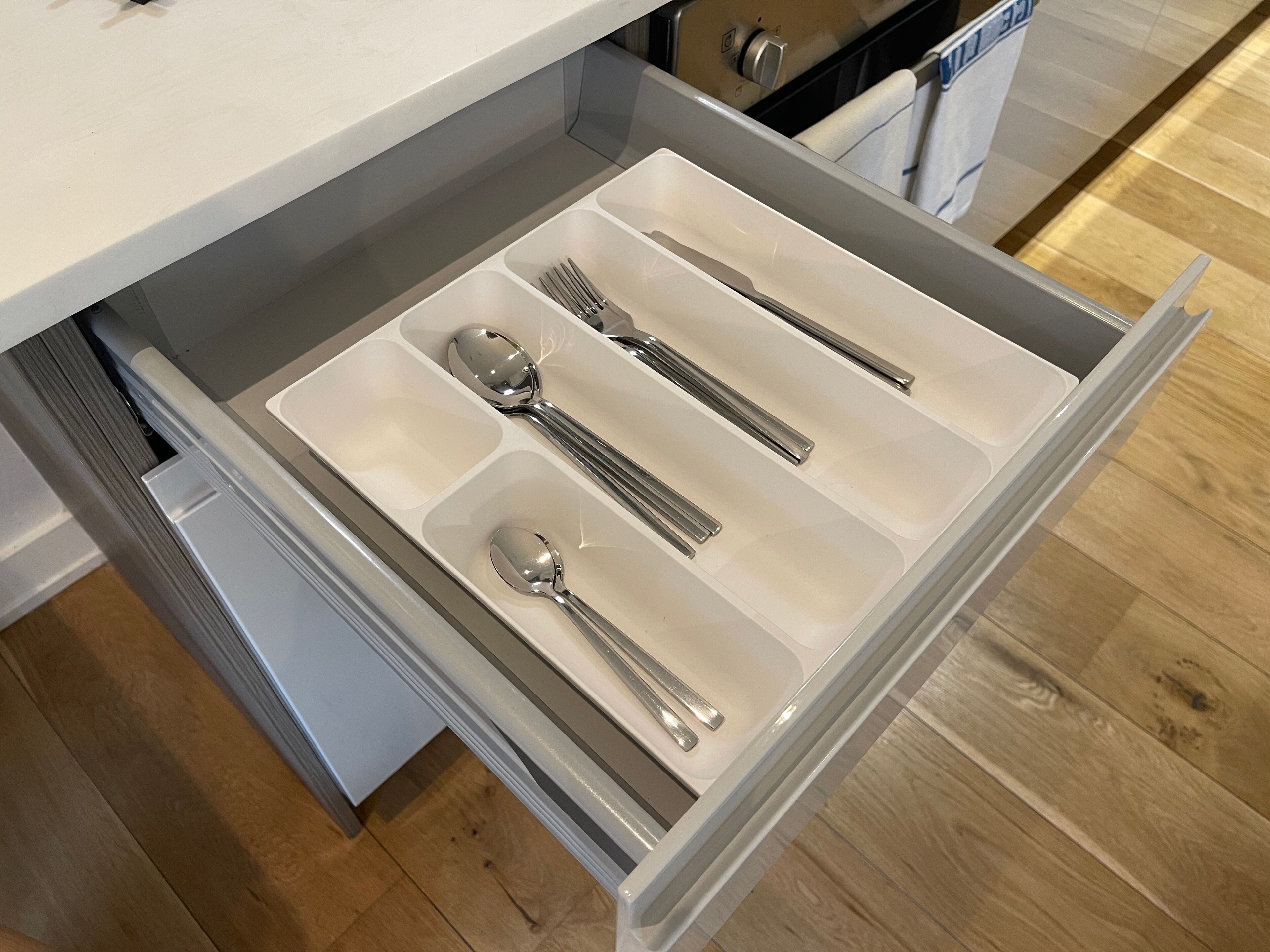 A kitchen drawer with utensils.