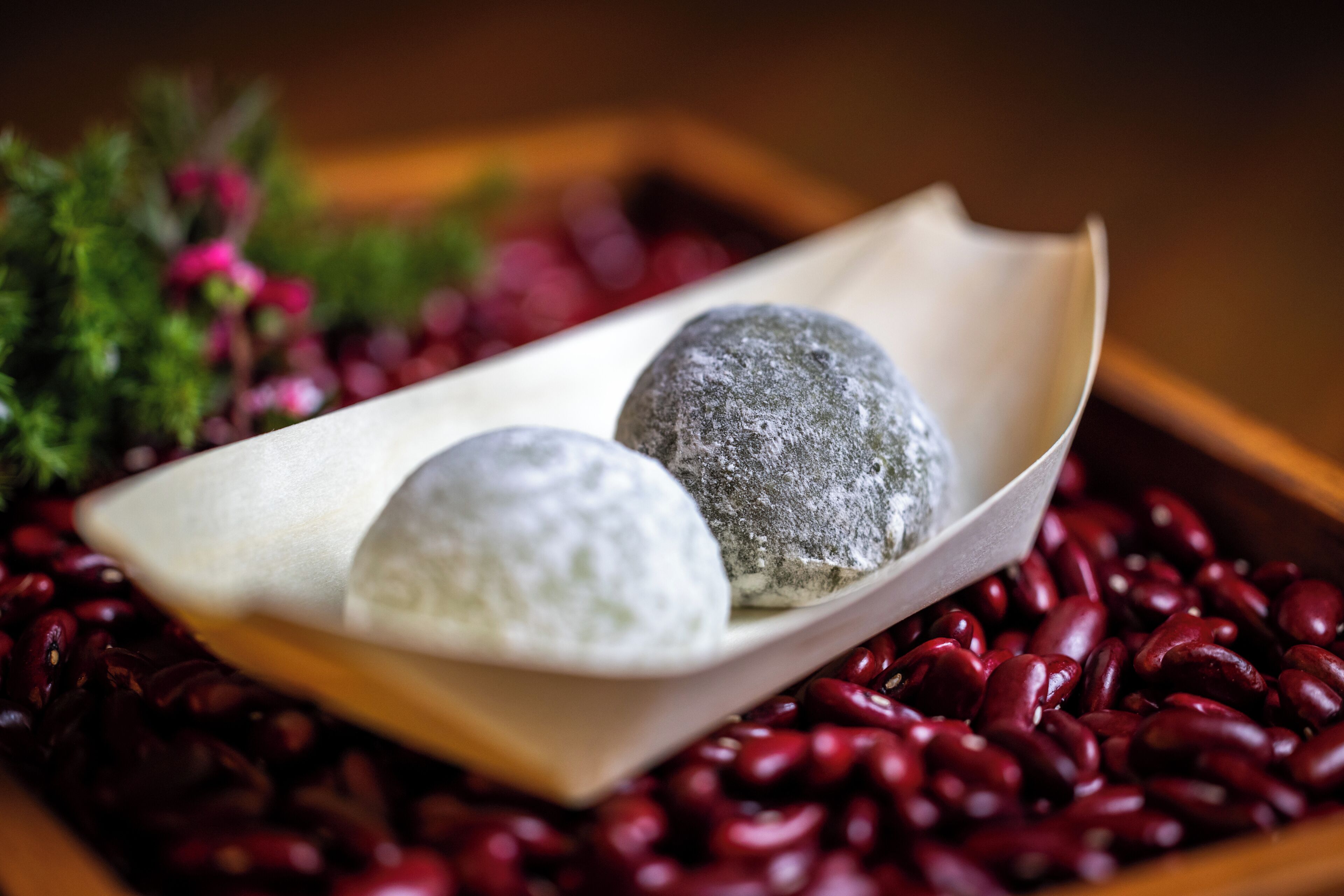 Three round objects on a white cloth, surrounded by red beans.
