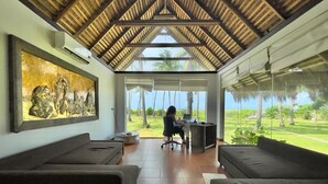 A room with a high ceiling, a large window, and a view of the outdoors. - Blue Whale beach boutique Resort (Kandakuliya)