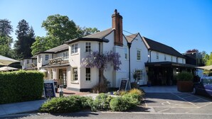 A traditional building with a sign reading 'The Royal,' a parking area, and a clear sky. - The Royal Foresters, Ascot, Berkshire - Acorn Pubs (Ascot)