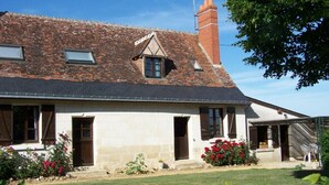A two-story house with a sloped roof, dormer windows, and a chimney. - Charming 18th Century Cottage with Pool, Near Loire Castles and Vineyards (Saint-Épain)