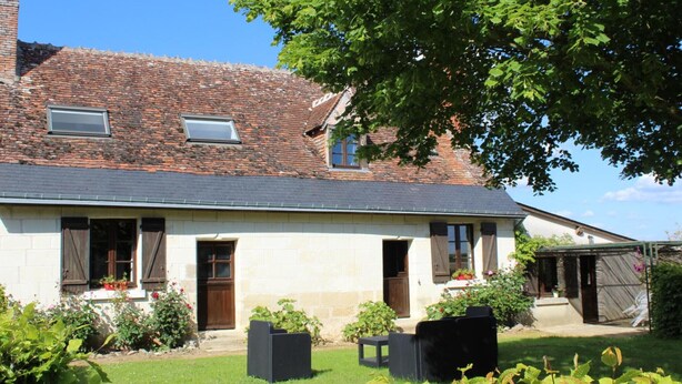 A two-story house with a brick roof, a small garden, and a covered porch. - Charming 18th Century Cottage with Pool, Near Loire Castles and Vineyards (Saint-Épain)