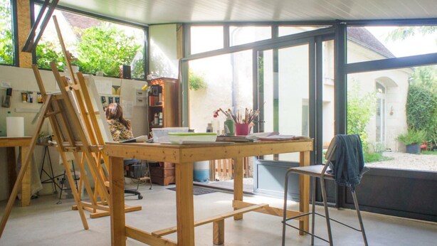A spacious room with large windows, a wooden table, a ladder, and a chair. - Charming house near Loire Valley Castles (Athée-sur-Cher)