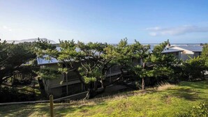 A residential area with houses, a grassy area, and a clear sky. - Gearhart House G607 (Gearhart)