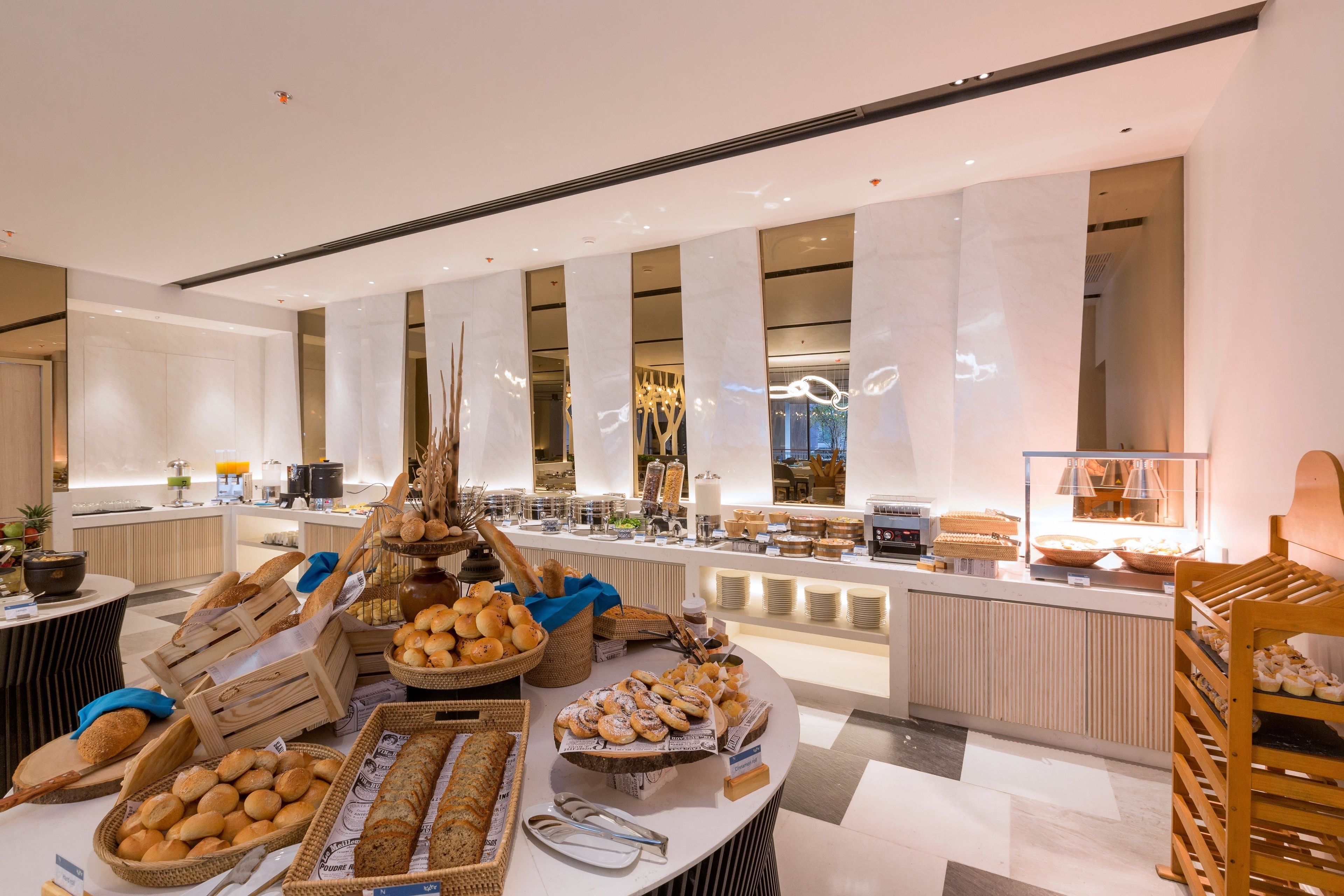A buffet area with various breads and pastries.