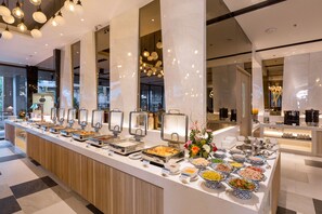 A buffet setup with various food stations and a modern interior design. - The Nature Phuket (Patong)