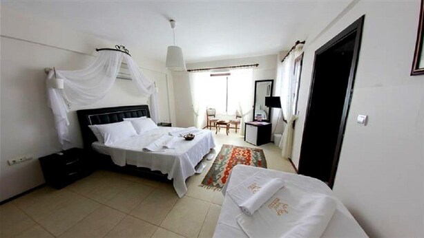 A hotel room with a bed, a desk, a chair, and a wardrobe. - Nano Hotel (Cesme)