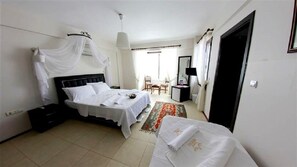 A hotel room with a bed, a desk, a chair, and a wardrobe. - Nano Hotel (Cesme)