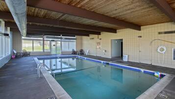 Relax by the pool, surrounded by a tiled edge and natural light.