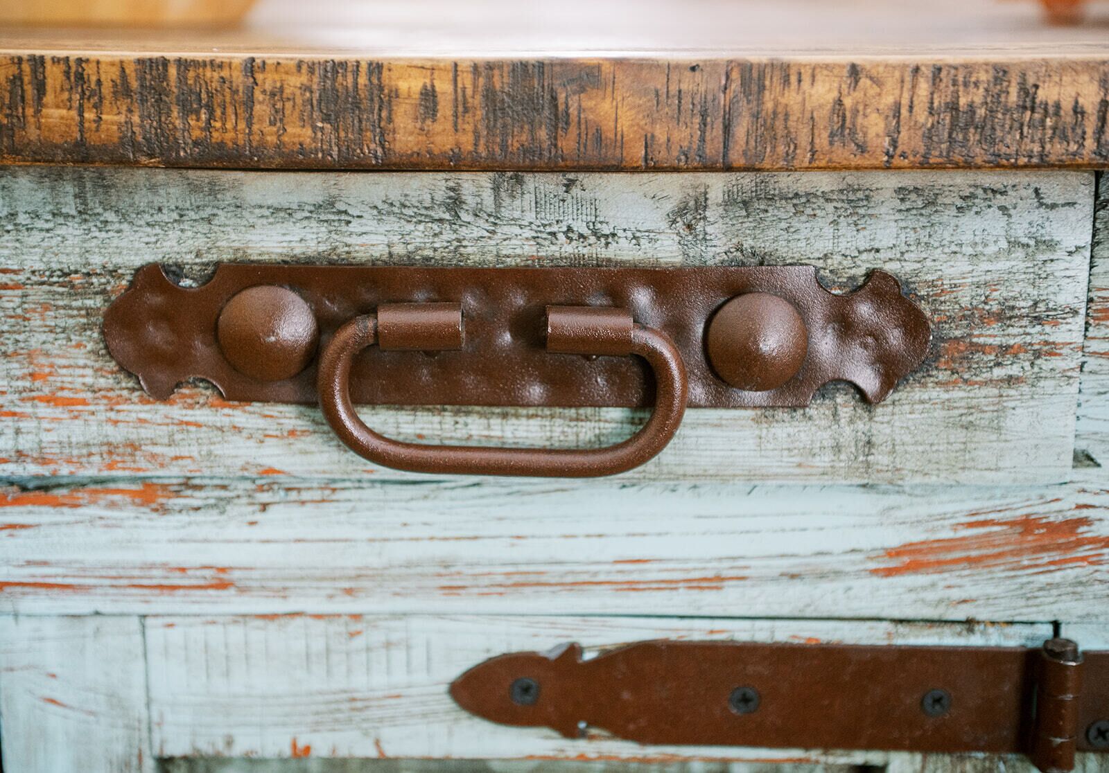 A rustic wooden chest with a metal latch and leather strap.