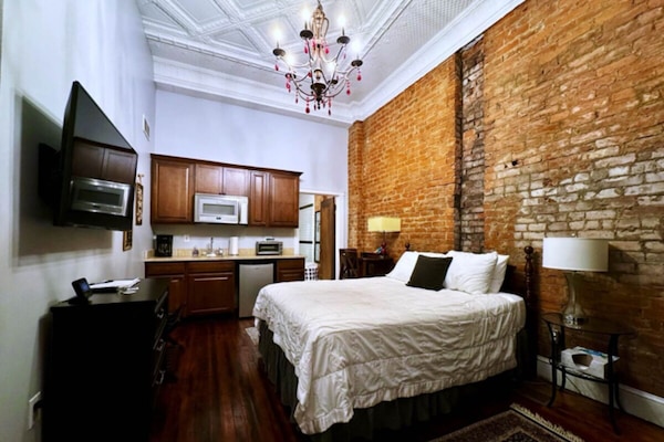 Beautiful living area with original 12’ tin-ceilings and hardwood floors!