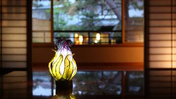 A lamp with a floral design on a reflective surface.