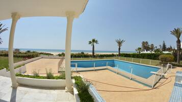 Kolam renang outdoor, dengan payung kolam renang dan kursi berjemur