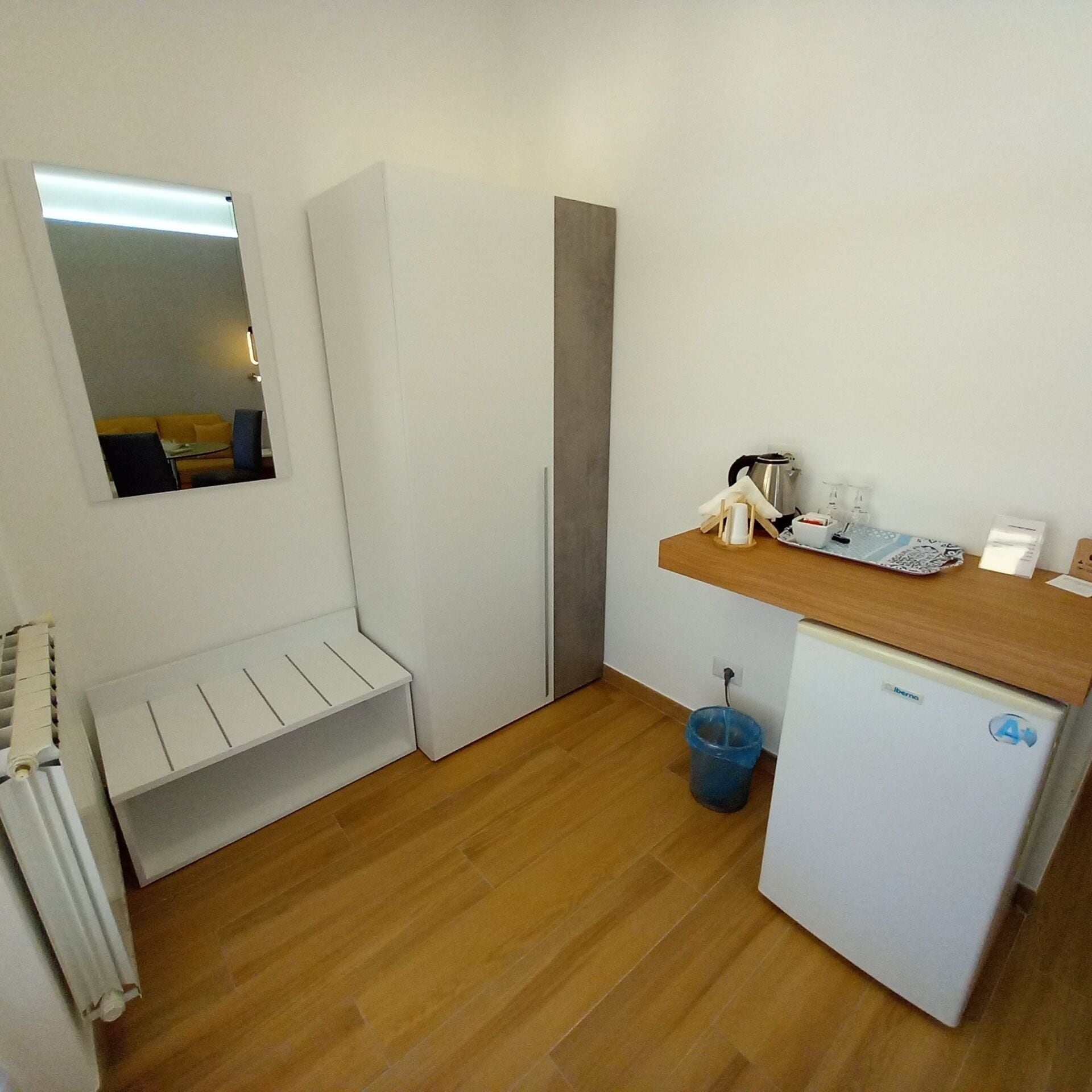 A compact kitchen with a refrigerator, a sink, and a small countertop.