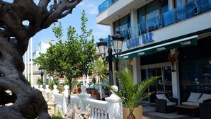 A lobby area with a bar named "Lobey Bar" and a TUBORG sign. There are potted plants and outdoor seating. - Kiten Beach (Kiten)