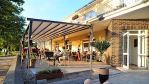An outdoor patio area with seating and potted plants.