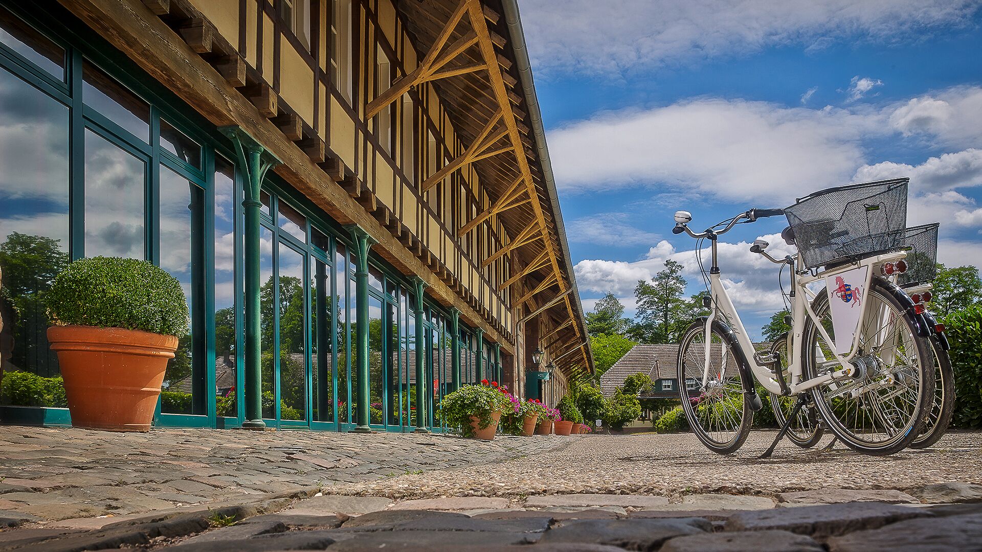 A building with large windows and a bicycle parked in front.