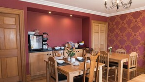 A dining area with wooden furniture and a coffee station. - Bishopcleugh Guest House (Lockerbie)