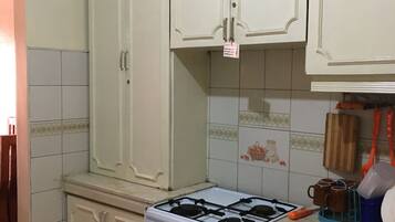 Full-size fridge, stovetop, electric kettle, rice cooker