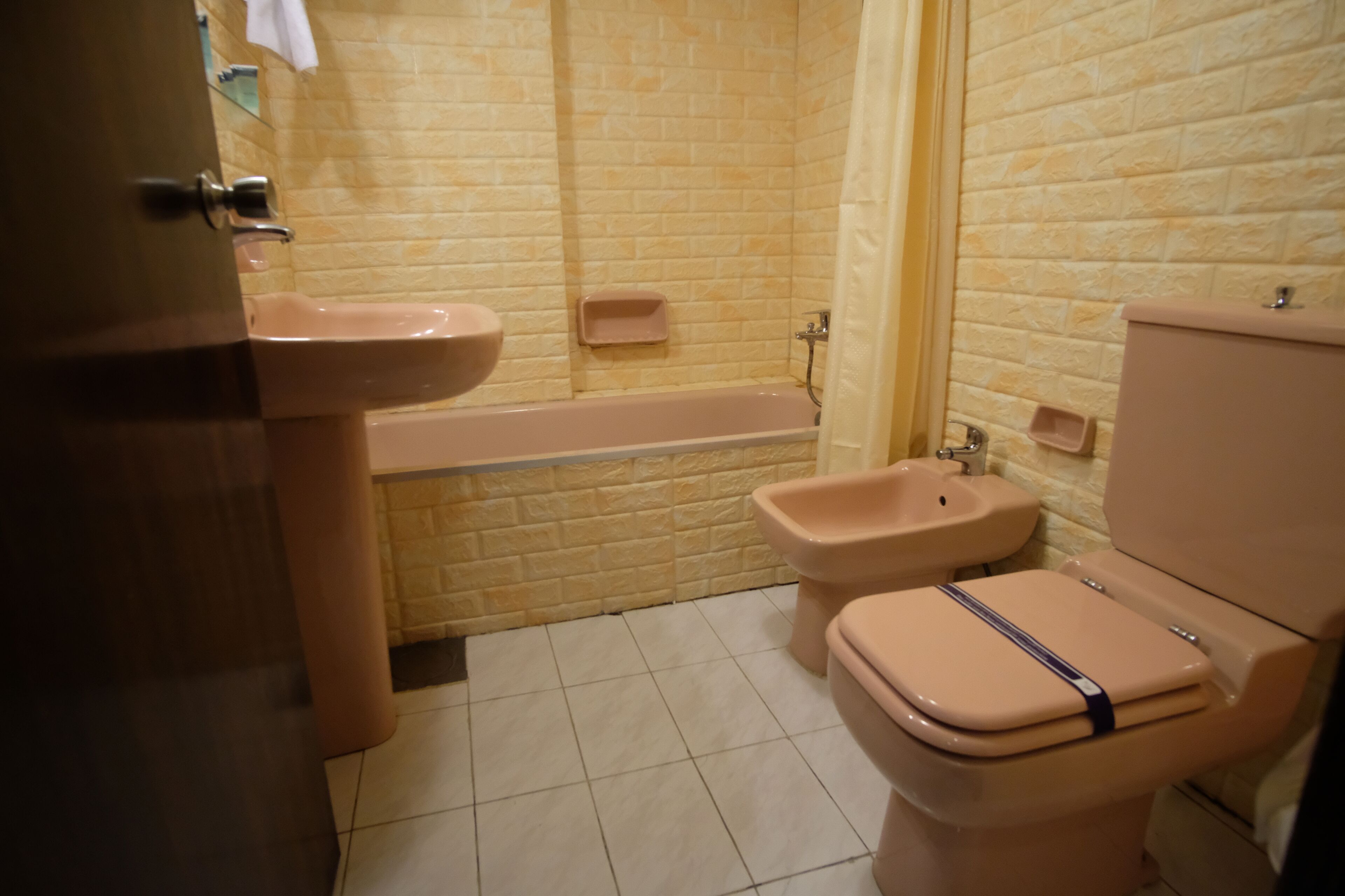 A bathroom with a bathtub, a toilet, and a sink.