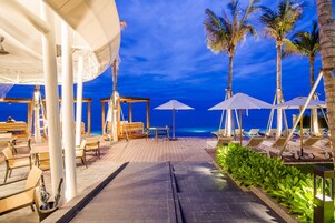 On the beach, white sand, beach umbrellas, beach towels