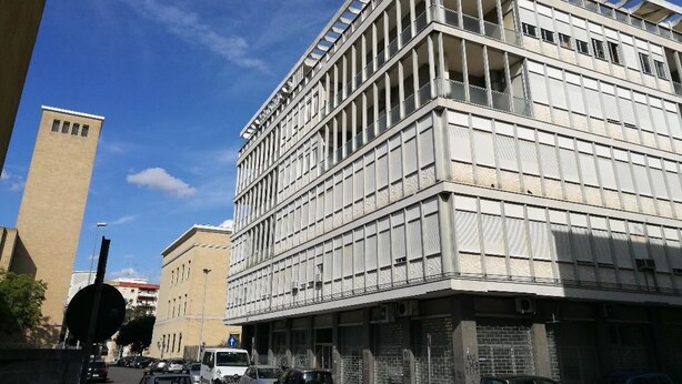 A modern building with a grid-like facade, large windows, and a flat roof. - B&B Domus Lupiae (Lecce)
