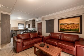 Classic Apartment, 3 Bedrooms, Patio | Living room | 40-inch LED TV with satellite channels, TV - Camelot Guest House & Apartments (Potchefstroom)