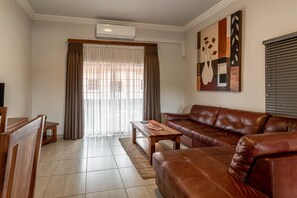 Classic Apartment, 2 Bedrooms, Balcony | Living room | 40-inch LED TV with satellite channels, TV - Camelot Guest House & Apartments (Potchefstroom)
