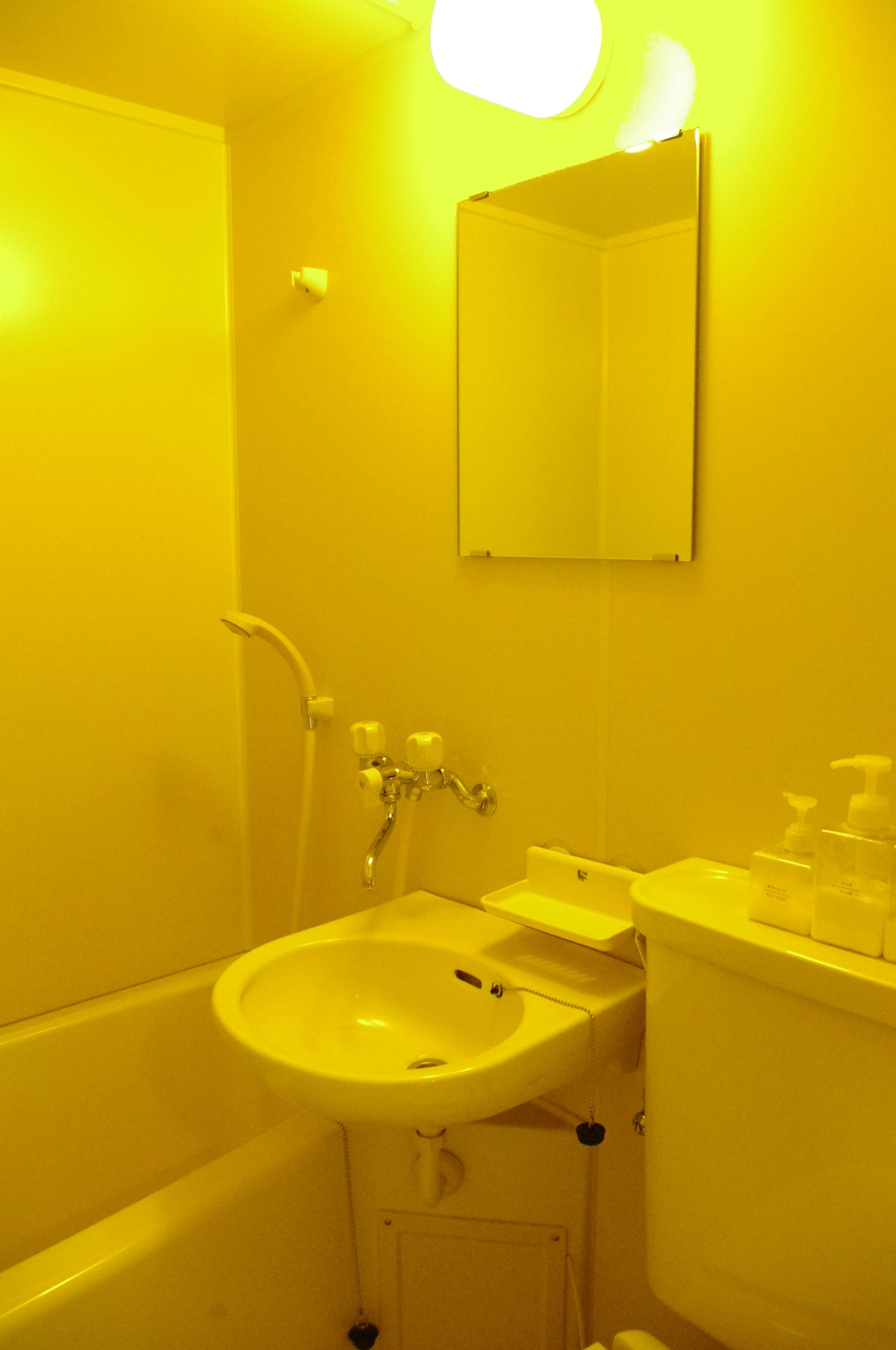 A bathroom with a bathtub, sink, and mirror.