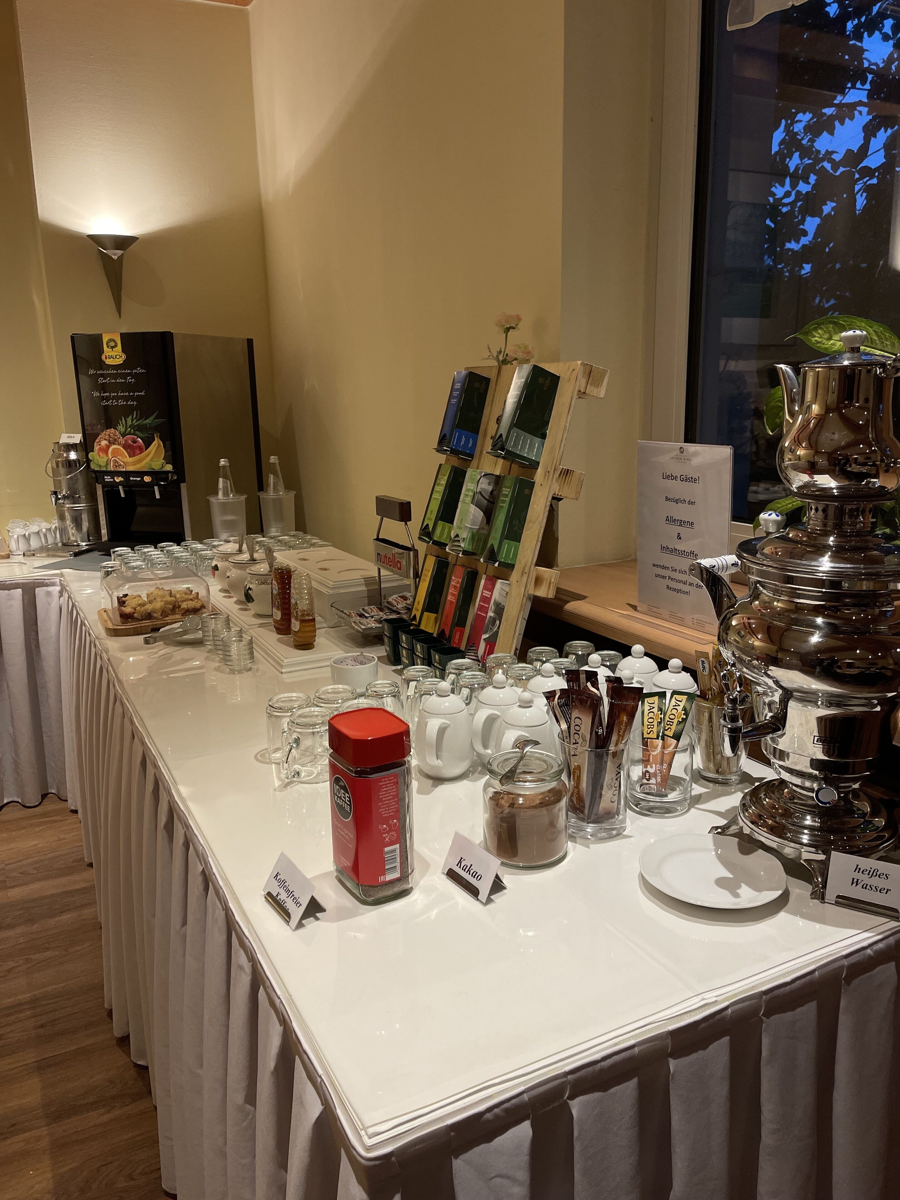 A buffet setup with various food items and condiments.