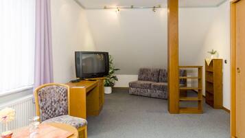 Quadruple Room | Living area | Flat-screen TV