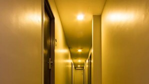 A hotel hallway with patterned carpet, doors, and lighting. - Prince 33 Hotel (Johor Bahru)