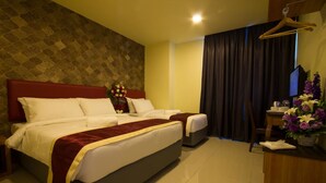 A hotel room with a large bed, a smaller bed, a desk with a chair, and a TV. - Prince 33 Hotel (Johor Bahru)