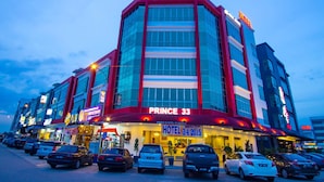 A hotel with a modern facade, multiple parking spaces, and a prominent 'PRINCE 33' sign. - Prince 33 Hotel (Johor Bahru)