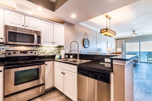 2 Bedroom Condo #1302 | Private kitchen | Full-sized fridge, microwave, oven, stovetop - Crystal Shores by Luxury Gulf Rentals (Gulf Shores)