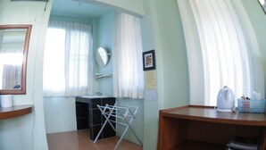 A small, well-lit room with a sink, mirror, and a drying rack. There is a wooden shelf with a kettle and a basket. - Maerim Whale Park Resort (Mae Rim)
