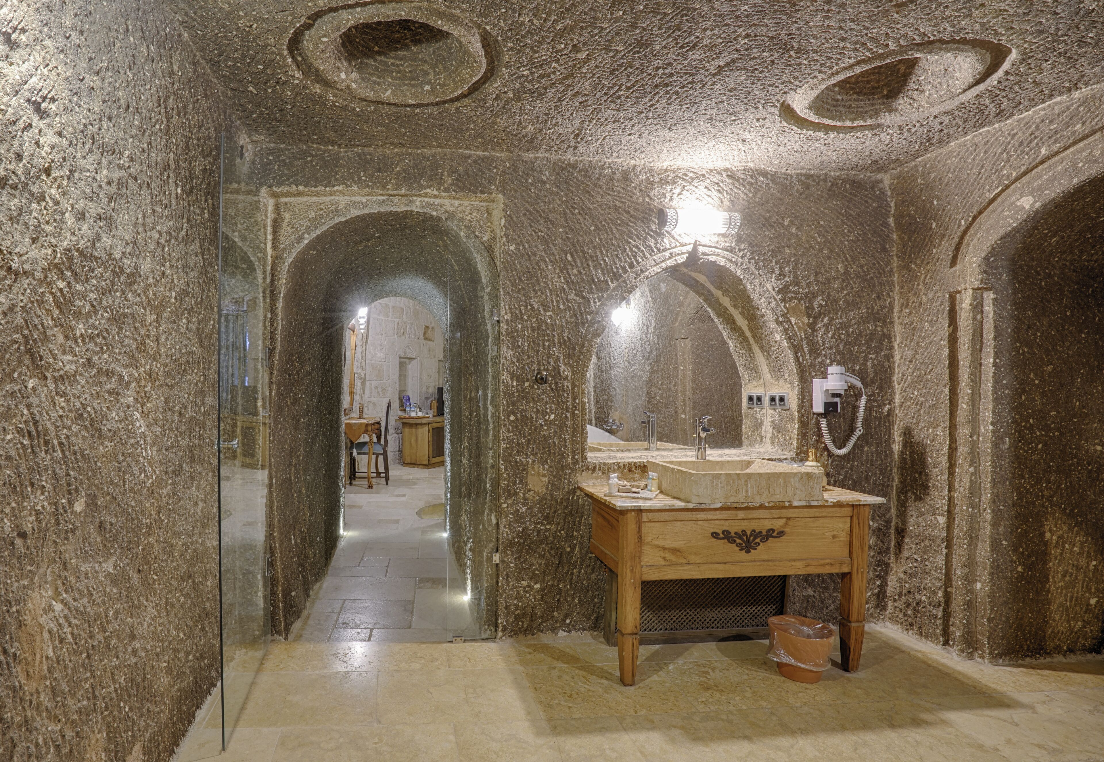 honeymoon cave suite room | bathroom | free toiletries, hair dryer, slippers, towels